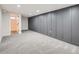 Spacious basement area featuring new carpet and a stylish wainscoting wall design at 2310 Willow Creek Dr, Golden, CO 80401