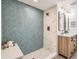 Modern bathroom with stylish blue tile shower, dual sinks, and wood cabinets at 2310 Willow Creek Dr, Golden, CO 80401