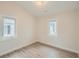 An empty bedroom with light wood flooring and natural light from two windows at 2310 Willow Creek Dr, Golden, CO 80401