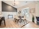 Bright dining area with a bay window and stylish decor and wood accent wall at 2310 Willow Creek Dr, Golden, CO 80401