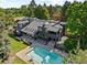 Expansive aerial view of home with a stunning backyard pool and outdoor lounge area at 1 Sedgwick Dr, Cherry Hills Village, CO 80113