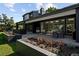Stylish backyard patio with comfortable seating and beautiful flower beds, perfect for outdoor relaxation at 1 Sedgwick Dr, Cherry Hills Village, CO 80113