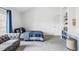 Bedroom featuring a gray couch, plaid bedding, blue built-in shelves, and a desk at 1 Sedgwick Dr, Cherry Hills Village, CO 80113