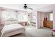 This charming bedroom has pink walls, built-in shelves, vanity, and an ensuite bathroom at 1 Sedgwick Dr, Cherry Hills Village, CO 80113