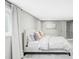 A peaceful bedroom featuring a large window, neutral colors, and soft textiles at 1 Sedgwick Dr, Cherry Hills Village, CO 80113