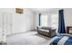 Spacious bedroom featuring a gray tufted sofa, large windows, and basketball hoop at 1 Sedgwick Dr, Cherry Hills Village, CO 80113