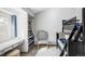 A cozy bedroom with a gray chair, built-in shelves, desk, and a bunk bed at 1 Sedgwick Dr, Cherry Hills Village, CO 80113