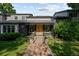 Charming home exterior featuring a welcoming brick pathway and well-maintained landscaping at 1 Sedgwick Dr, Cherry Hills Village, CO 80113