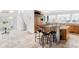 Bright and open kitchen featuring stone floors, counter seating, and views to the breakfast nook at 1 Sedgwick Dr, Cherry Hills Village, CO 80113