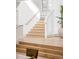 Elegant staircase with natural wood steps and a stylish handrail at 1 Sedgwick Dr, Cherry Hills Village, CO 80113