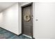 Apartment unit entrance with gray door, wreath, and number 305 at 14351 E Tennessee Ave # 305, Aurora, CO 80012