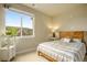 Charming bedroom with wood bed frame and window at 14351 E Tennessee Ave # 305, Aurora, CO 80012