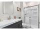 Bathroom with modern vanity, framed mirror, and glass enclosed shower at 11103 Cloud Shadow St, Littleton, CO 80125
