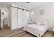 Bedroom featuring wood floors, barn doors, and closet at 11103 Cloud Shadow St, Littleton, CO 80125