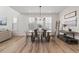 Bright dining area with wood floors, modern chandelier and large windows with plantation shutters at 11103 Cloud Shadow St, Littleton, CO 80125