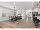 Open-concept dining area featuring wood floors, modern chandelier, leading into the kitchen at 11103 Cloud Shadow St, Littleton, CO 80125