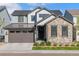 Beautiful two-story home with stone and siding, a well-manicured lawn and a two car garage at 11103 Cloud Shadow St, Littleton, CO 80125