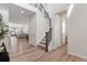 Inviting home foyer with hardwood floors and staircase with metal railing at 11103 Cloud Shadow St, Littleton, CO 80125