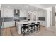 Contemporary kitchen with white cabinetry, gray backsplash, quartz island and stainless-steel appliances at 11103 Cloud Shadow St, Littleton, CO 80125