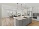 Spacious open-concept kitchen with large center island, stainless steel appliances and dining area at 11103 Cloud Shadow St, Littleton, CO 80125