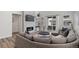 Living room boasts tile fireplace, a mounted TV, a sliding door, and a large wraparound couch at 11103 Cloud Shadow St, Littleton, CO 80125