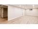 Spacious finished basement with light-colored laminate flooring at 2355 Cherryville Rd, Greenwood Village, CO 80121