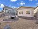 Cozy backyard featuring stone fire pit, gravel landscaping and lush yard at 8894 River Peak Cir, Littleton, CO 80125