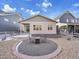 Landscaped backyard featuring gravel, a fire pit, and bordered landscaping at 8894 River Peak Cir, Littleton, CO 80125