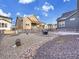 Spacious backyard boasts stylish landscaping with a fire pit and decorative gravel at 8894 River Peak Cir, Littleton, CO 80125