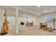 Open basement area perfect for entertaining, featuring comfortable seating and ample lighting at 8894 River Peak Cir, Littleton, CO 80125