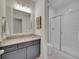 Bright bathroom with granite countertop, sleek vanity, and glass-enclosed shower at 8894 River Peak Cir, Littleton, CO 80125