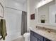 Modern bathroom features a tub with tile surround and a vanity with granite countertop at 8894 River Peak Cir, Littleton, CO 80125