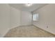 Bright bedroom features neutral walls, carpet flooring, and a window for natural light at 8894 River Peak Cir, Littleton, CO 80125