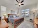 Comfortable bedroom with a ceiling fan, large window, and a wood-frame bed at 8894 River Peak Cir, Littleton, CO 80125