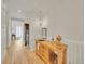 Bright hallway featuring hardwood floors, white wainscoting, stylish lighting, and elegant home décor at 8894 River Peak Cir, Littleton, CO 80125