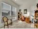 Sunlit office space boasts large windows, neutral carpet and ample room for desk and bookshelves at 8894 River Peak Cir, Littleton, CO 80125