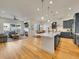 Spacious open floor plan with a modern kitchen, cozy fireplace, and elegant hardwood floors at 8894 River Peak Cir, Littleton, CO 80125