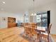 Spacious living space featuring hardwood floors, a wooden table, and natural light at 8894 River Peak Cir, Littleton, CO 80125
