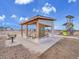A park pavilion offering picnic tables and a grill surrounded by grass, providing a space for outdoor gatherings at 8894 River Peak Cir, Littleton, CO 80125