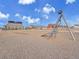 Modern playground equipment and soft surface ground cover offer a safe play area, promoting outdoor activities for children at 8894 River Peak Cir, Littleton, CO 80125