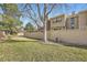 Grassy backyard features a wooden fence, mature trees, and some shrubbery at 7925 W Layton Ave # 529, Littleton, CO 80123