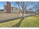 Backyard features a grassy area, a wooden fence, and mature trees at 7925 W Layton Ave # 529, Littleton, CO 80123