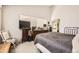 Comfortable bedroom features soft light, and an attached bathroom with a large dresser at 7925 W Layton Ave # 529, Littleton, CO 80123