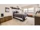 Comfortable bedroom features soft light, a window, and a trunk for storage and decoration at 7925 W Layton Ave # 529, Littleton, CO 80123