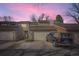 Charming townhome featuring a two-car garage with a vivid pink sky at 7925 W Layton Ave # 529, Littleton, CO 80123