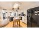 Bright kitchen features white cabinets, black appliances, and wood floors for a classic look at 7925 W Layton Ave # 529, Littleton, CO 80123