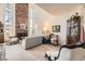 Bright living room with a brick fireplace, tall windows, and comfortable seating at 7925 W Layton Ave # 529, Littleton, CO 80123