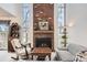 Cozy living room featuring a fireplace, large windows, and classic decor at 7925 W Layton Ave # 529, Littleton, CO 80123