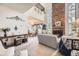 Bright living room with a brick fireplace and views into the dining area at 7925 W Layton Ave # 529, Littleton, CO 80123