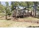 Home exterior with a backyard featuring a deck, patio, and lush green lawn at 5184 Pinyon Jay Rd, Parker, CO 80134